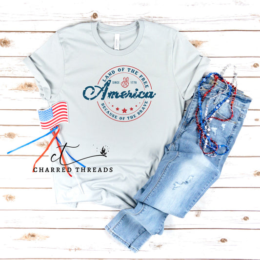 Land of the Free Because of the Brave Short Sleeve Graphic T-Shirt